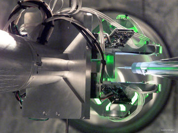 The target positioner and target alignment system precisely locate a target in the NIF target chamber. The target is positioned with an accuracy of less than the thickness of a human hair.